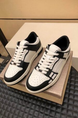 Amiri Skel-Top Low-Top Sneakers in Black and White.