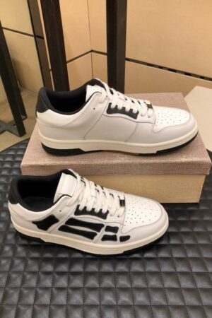 Amiri Skel-Top Low-Top Sneakers in White and Black.