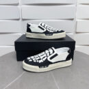 Amiri Skel-Top Slip-On Sneakers in Black and White.