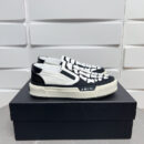Amiri Skel-Top Slip-On Sneakers in Black and White.