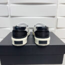 Amiri Skel-Top Slip-On Sneakers in Black and White.
