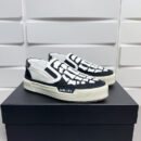 Amiri Skel-Top Slip-On Sneakers in Black and White.