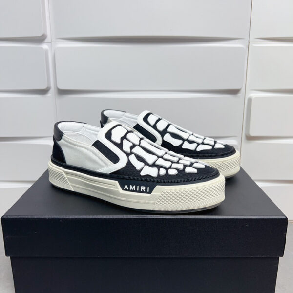 Amiri Skel-Top Slip-On Sneakers in Black and White.