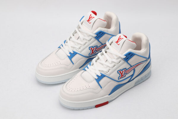 A white low-top sneaker with vibrant blue accents along the side and heel, dynamic red stripes highlighting the side logo, and white laces, set against a clean white background.