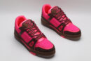 A single pink and brown Louis Vuitton LV Trainer sneaker, covered in glittering pink crystal embellishments, with "VUITTON" visible on the side strap