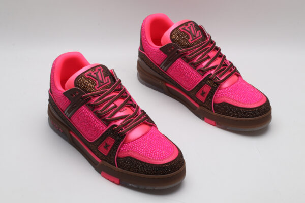 A single pink and brown Louis Vuitton LV Trainer sneaker, covered in glittering pink crystal embellishments, with "VUITTON" visible on the side strap