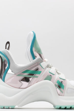 : A pair of black chunky athletic sneakers with brown monogram patterns on the toe and sides, black laces, a prominent black sculptural wavy sole, and a high ankle collar, displayed against a plain white background.