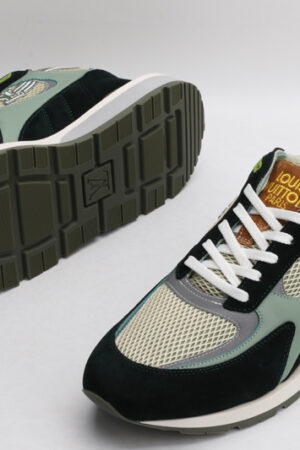 A pair of athletic sneakers in shades of forest green, earthy brown, black, and light olive mesh, featuring white laces, prominent "LOUIS VUITTON PARIS" branding on the tongue, and a layered sole, displayed from a top-down angle against a plain white background.