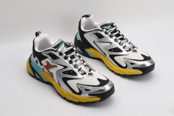A pair of Louis Vuitton LV Runner Tatic Sneakers, showcasing white mesh, black and silver overlays, a vibrant yellow sole, and blue accents, viewed from a slightly elevated angle.