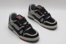 A pair of black and silver Louis Vuitton LV Trainer sneakers, entirely covered in glittering black and silver crystal embellishments, with "VUITTON" visible on the side strap