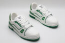 A single white and green Louis Vuitton LV Trainer sneaker, covered in glittering green crystal embellishments, with "VUITTON" visible on the outsole.
