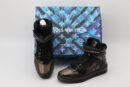 A pair of translucent black Louis Vuitton LV Trainer Up high-top sneakers with velcro straps, black laces, and a black sole