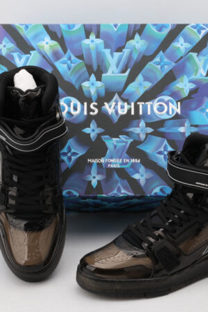 A pair of translucent black Louis Vuitton LV Trainer Up high-top sneakers with velcro straps, black laces, and a black sole
