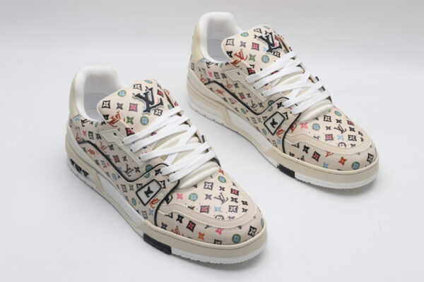 A single beige Louis Vuitton LV Trainer Low-Top Sneaker with an all-over multi-color Louis Vuitton Monogram pattern, showcasing its detailed design and white sole.