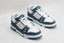 A pair of Louis Vuitton LV Trainer Low-Top Sneakers in blue denim and white, viewed from an elevated angle, showcasing both shoes with blue denim panels and white leather details.