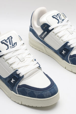 A single blue denim and white Louis Vuitton LV Trainer Low-Top Sneaker, showcasing its full design from a slight angle.