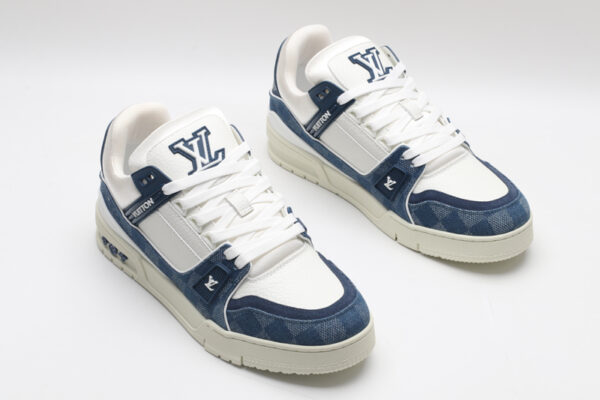A single blue denim and white Louis Vuitton LV Trainer Low-Top Sneaker, showcasing its full design from a slight angle.