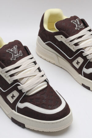 A single brown Louis Vuitton LV Trainer Low-Top Sneaker, showcasing its embossed monogram suede and off-white accents.