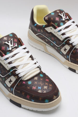 A single brown Louis Vuitton LV Trainer Low-Top Sneaker with an all-over multi-color Louis Vuitton Monogram pattern, showcasing its detailed design and white sole.