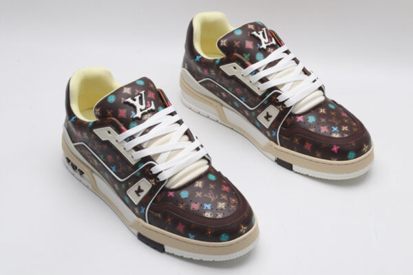 A single brown Louis Vuitton LV Trainer Low-Top Sneaker with an all-over multi-color Louis Vuitton Monogram pattern, showcasing its detailed design and white sole.
