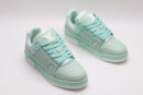 A pair of mint green Louis Vuitton LV Trainer Low-Top Sneakers, showcasing their full design from a slight angle.