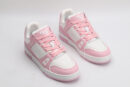 A pair of white and pink Louis Vuitton LV Trainer Low-Top Sneakers, with the right shoe displayed with its sole facing up, showcasing the white and pink outsole with "VUITTON" branding.