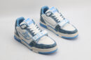 A pair of Louis Vuitton LV Trainer Mid-Top Sneakers in white and blue denim, viewed from an elevated angle, showcasing both shoes with blue denim panels, white leather details,