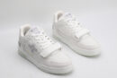 A pair of Louis Vuitton LV Trainer Mid-Top Sneakers in white and grey, viewed from an elevated angle, showcasing both shoes with white leather and mesh panels, grey suede accents, and a prominent white strap.