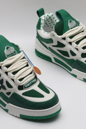 A single green and white Louis Vuitton LV Trainer sneaker, showcasing its vibrant color blocking, mesh panels, and robust sole.
