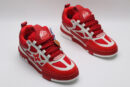 A single red and white Louis Vuitton LV Trainer sneaker, showcasing its vibrant color blocking, mesh panels, and robust sole.