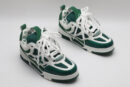 A single white and green Louis Vuitton LV Trainer sneaker, showcasing its bicolor design, mesh panels, and robust outsole.