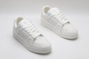 A single white and grey Louis Vuitton LV Trainer sneaker, showcasing its clean bicolor design, textured panels, and robust outsole.