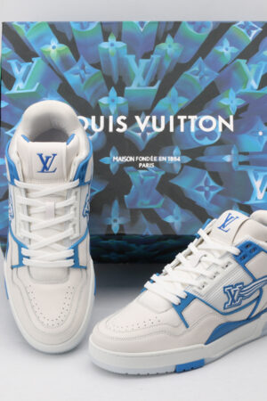 A pair of white and blue Louis Vuitton LV Trainer sneakers with clear sole elements revealing LV monograms