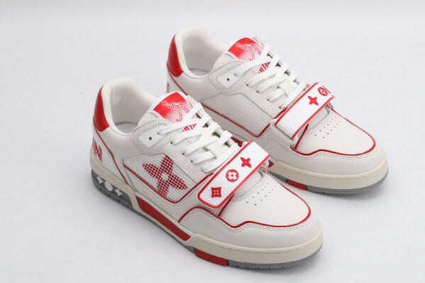 A pair of CrimsonFlash White and Red Sneakers, viewed at an angle, showcasing their low-top design, white laces, crisp white leather upper, vibrant red accents on the heel, outsole, and strap, and breathable white mesh side panels."