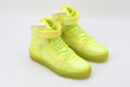 A single LuminousHi Neon Yellow High-Top Sneaker, shown in profile, featuring a translucent neon yellow upper, white padded collar, white laces, a translucent Velcro ankle strap, and a translucent neon yellow outsole.