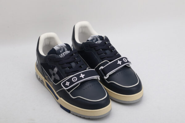 "A pair of OceanDepth Navy and White Urban Sneakers, viewed from the top, showcasing their low-top design, white laces, deep navy leather, white piping, mesh panels, and distinctive strap across the vamp."