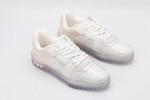 A pair of luminous iridescent holographic low-top sneakers with a clear, color-shifting upper, white laces, and a textured translucent sole, presented against a pure white background