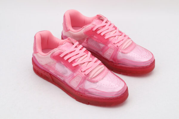A pair of vibrant translucent pink low-top sneakers with matching laces and a clear pink sole, displayed against a clean white background.