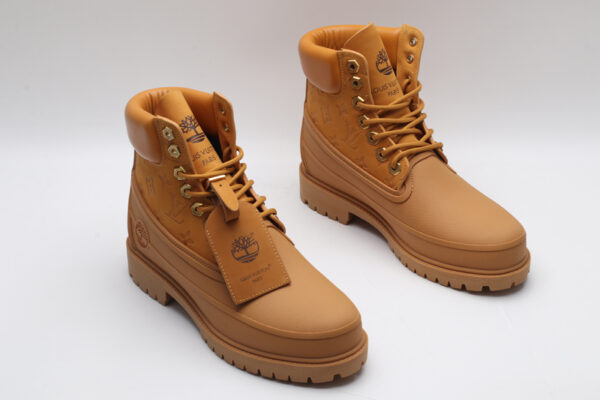 A single classic tan Timberland x Louis Vuitton collaborative waterproof boot, featuring the Timberland tree logo and subtle Louis Vuitton monogram debossing on the side.