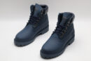 A pair of navy blue Timberland x Louis Vuitton collaborative waterproof boots, featuring the Timberland tree logo and subtle Louis Vuitton monogram debossing on the upper