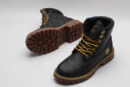 A pair of olive green Timberland x Louis Vuitton collaborative waterproof boots, featuring the Timberland tree logo and subtle Louis Vuitton monogram debossing on the upper.