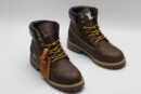 A single brown Timberland x Louis Vuitton collaborative waterproof boot, featuring the all-over Louis Vuitton monogram pattern, yellow and red laces, and the Timberland tree logo.