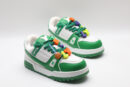 A single white and green Louis Vuitton LV Trainer Low-Top Sneaker, showcasing its full design from a slight angle, with bright orange and purple lace accents.