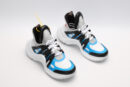 A pair of white, sky blue, and black chunky sneakers with a prominent white platform sole and a ridged bottom. The shoes are shown from a side angle, with one shoe propped against the other to showcase the sole's texture and branding. A yellow branded tag hangs from one of the laces.