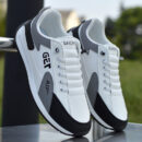 A pair of white unisex sneakers with black and gray accents, featuring a "TOSHA" logo on the side and a textured sole.