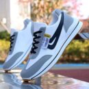 A pair of unisex low-top casual sneakers in white and gray with blue accents and a simple, streamlined design.