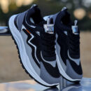 A pair of black and white low-top unisex athletic trainers with a lace-up design, a chunky sole, and the brand name CALCETTO on the side.