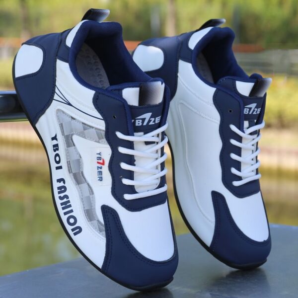 A pair of white and blue unisex sneakers with black accents and a cushioned sole, shown leaning against a wall.
