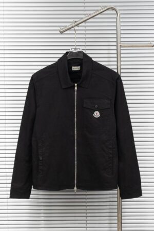 Black cotton or canvas Moncler field jacket with a full zip closure, a classic collar, and a Moncler logo patch on the chest pocket.