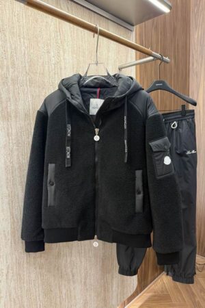 A Moncler hybrid jacket combining quilted, down-filled panels on the body with solid fleece sleeves, featuring the Moncler logo patch.